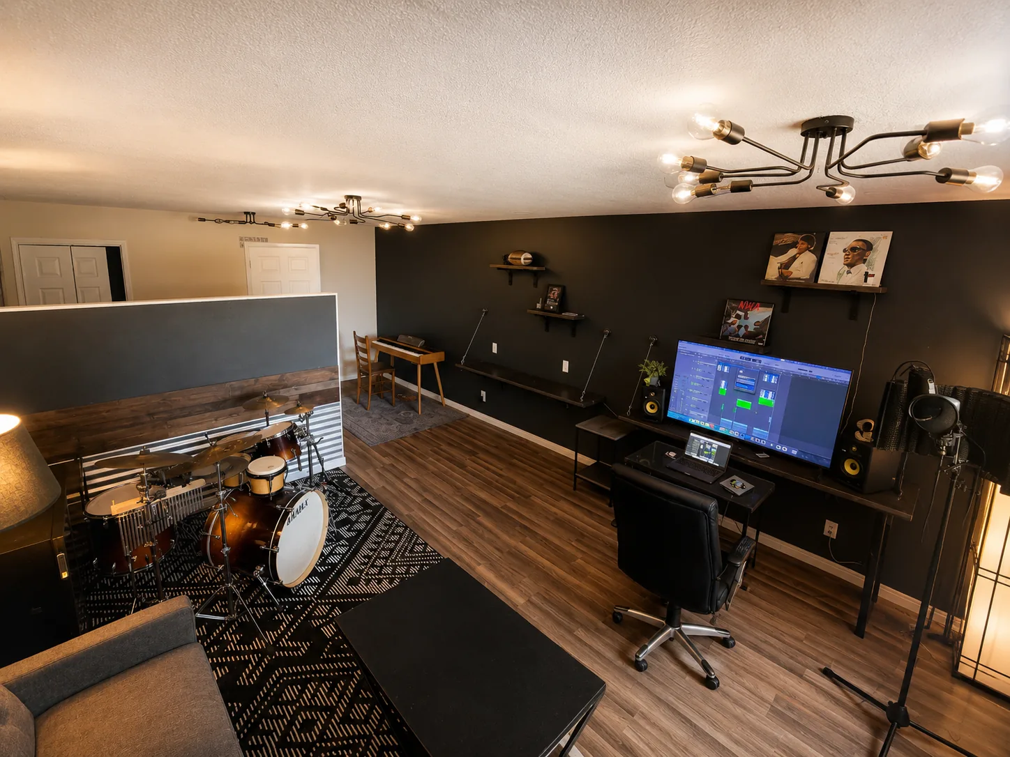 CalvinSunday Redding studio — production desk with DAW, monitors and drum kit