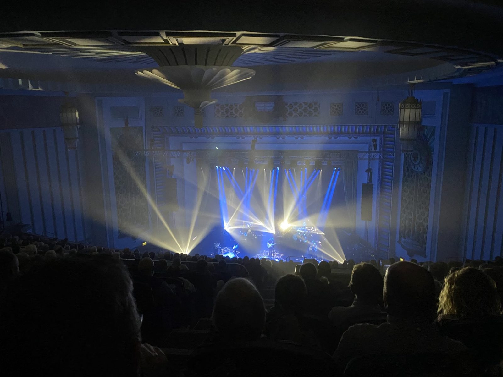 Congregation worshipping with stage lighting during a live service