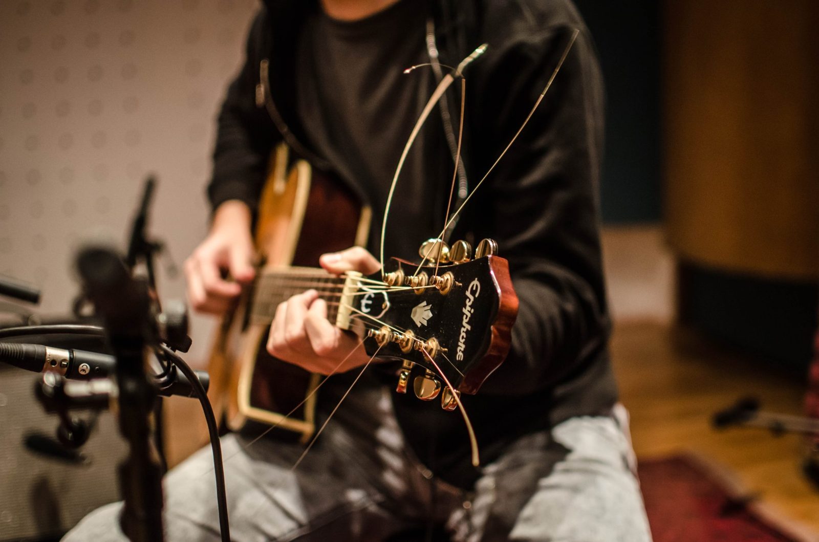 Guitarist playing into a microphone during a worship set
